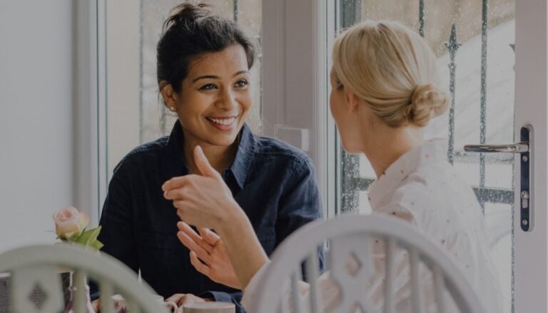 Two young women discussing life insurance options for women