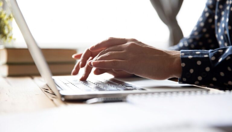 Person typing on a laptop looking for life insurance