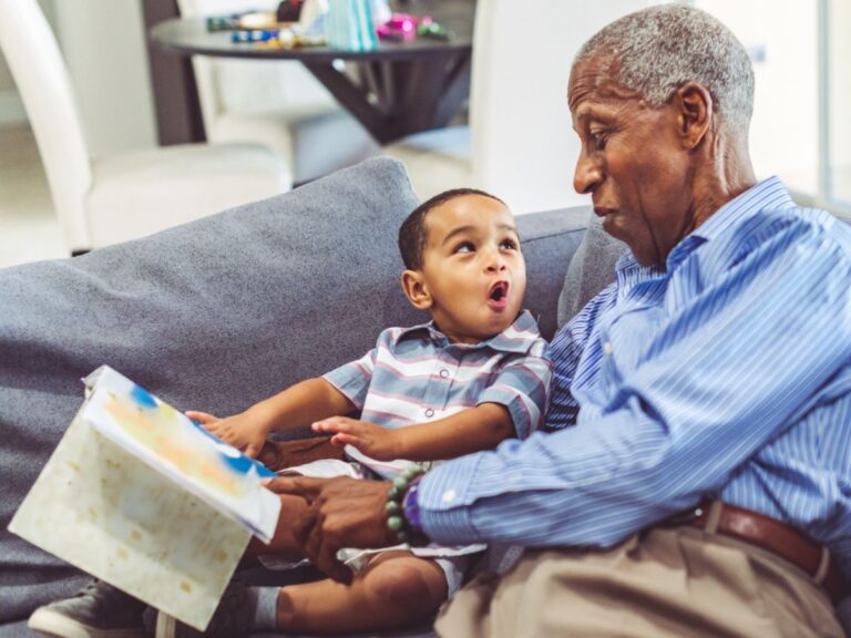 senior and grandchild reading together