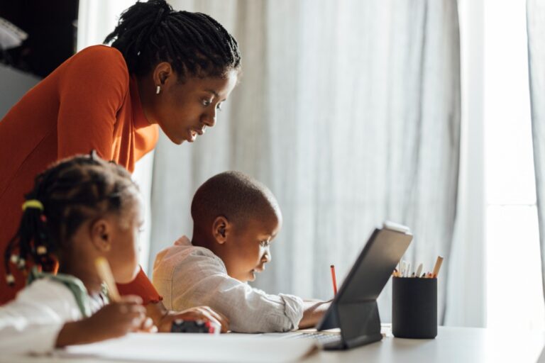 Mother helping children with homework