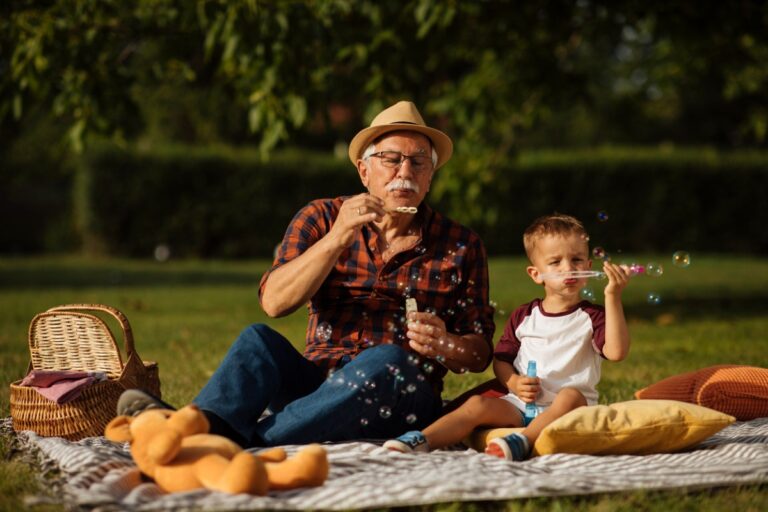 grandfather and grandson blowing bubbles