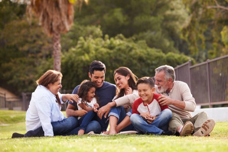 family sitting on grass