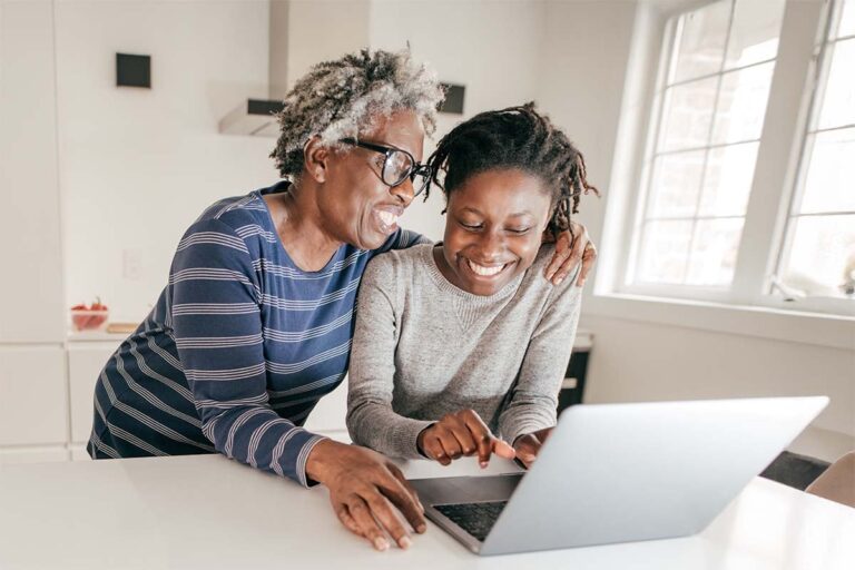 Older mother and daughter planning effective inheritance on a laptop